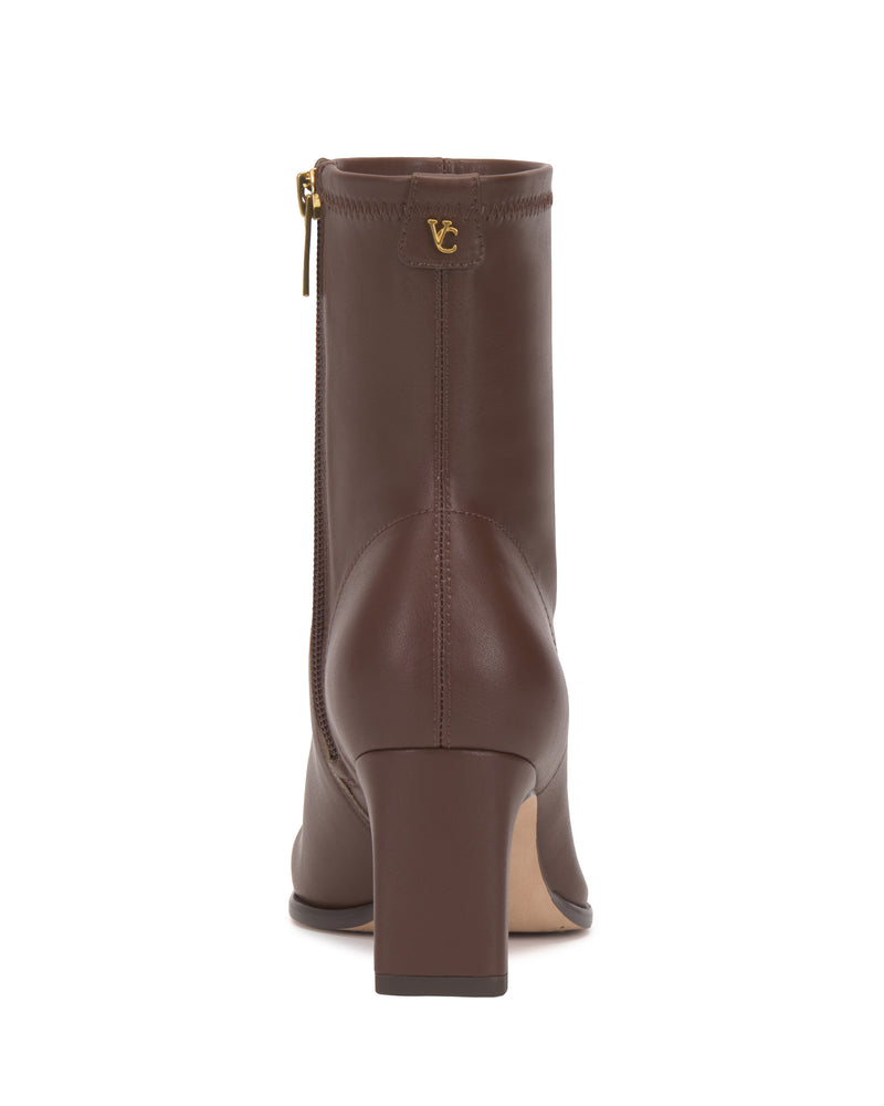 Rear view of the Vince Camuto Julea Bootie in brown, featuring a block heel, a side zipper, a smooth leather finish, and a small gold VC logo near the top.