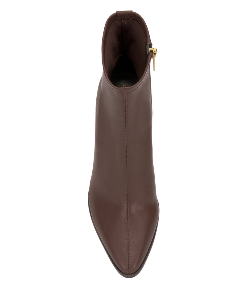 The Julea Bootie by Vince Camuto is a brown leather ankle boot with a pointed toe, viewed from above. It features a side zipper with a gold-colored pull and is displayed on a white background.