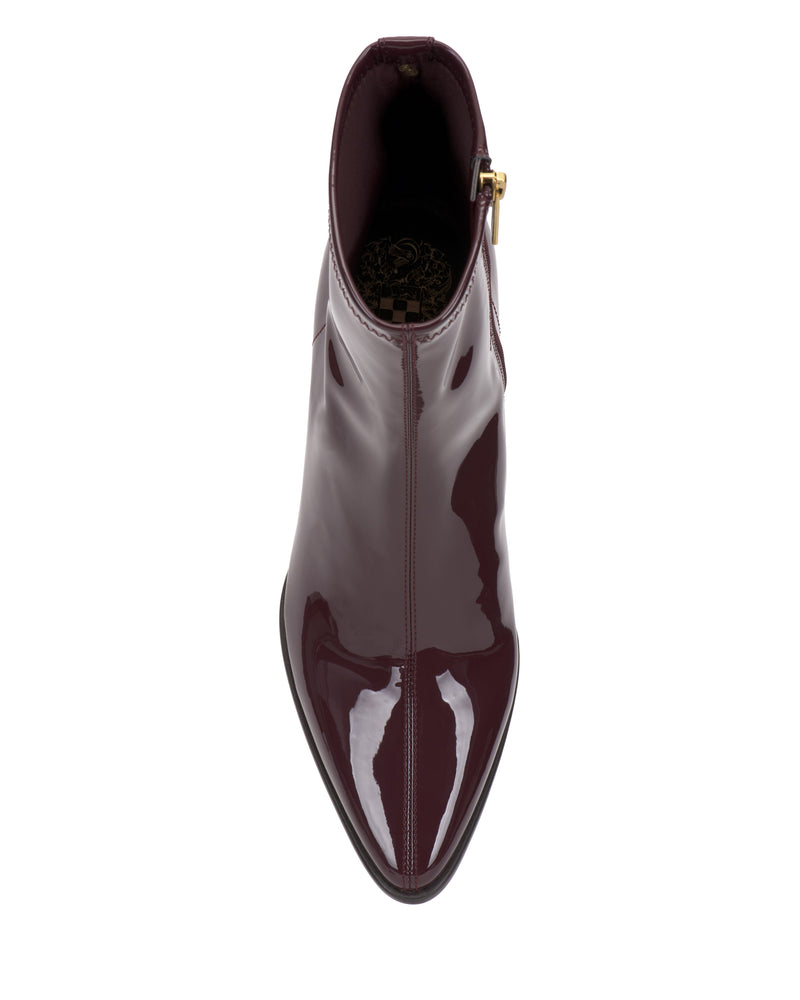 A top-down view of a high-gloss burgundy Vince Camuto Julea Bootie featuring a side zipper.