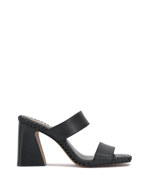The Vince Camuto Kaden Mule features black block heels, two wide foot straps, an open toe, flared heel, and boho-inspired braided detailing along the woven midsole.