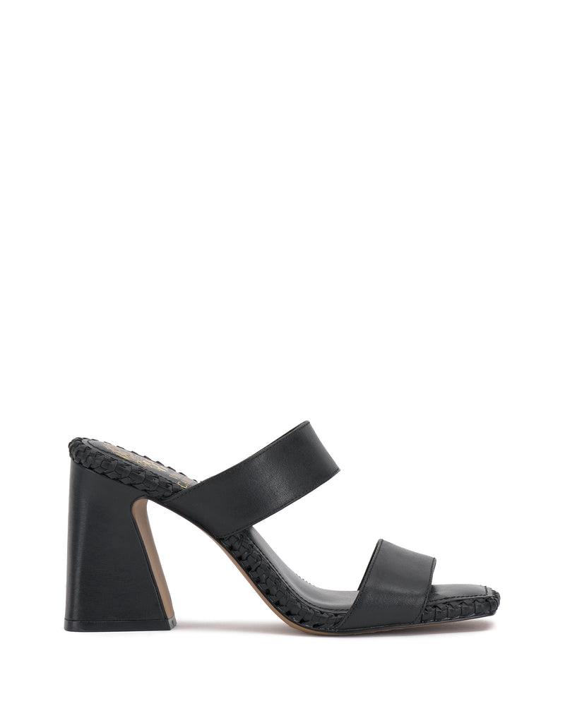 The Vince Camuto Kaden Mule features black block heels, two wide foot straps, an open toe, flared heel, and boho-inspired braided detailing along the woven midsole.