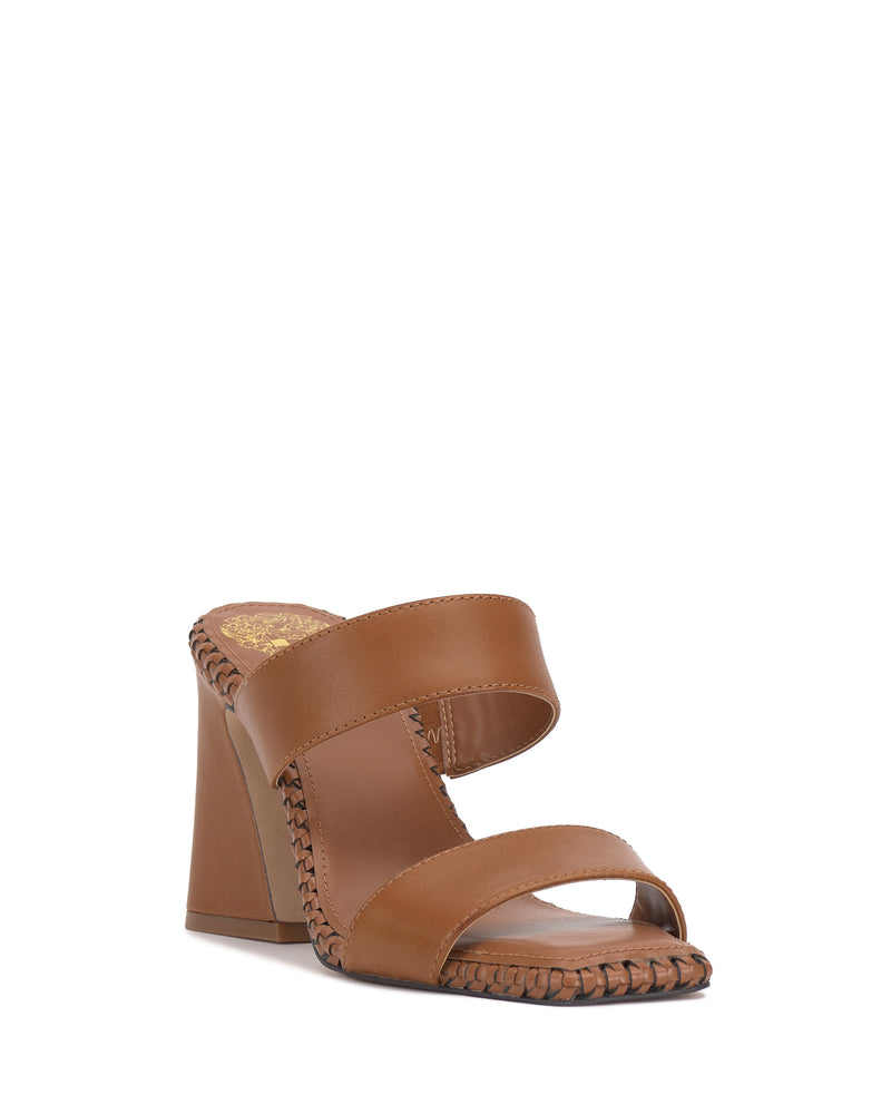 The Vince Camuto Kaden Mule is a brown block heel sandal featuring two wide leather straps, decorative stitching on the woven midsole, a solid high heel, and an open toe design for a chic, stylish look.