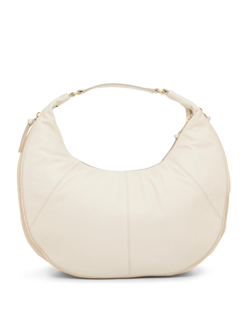 The Vince Camuto Kaela Hobo Bag features off-white leather in a large crescent shape with a thick matching handle and gold hardware, creating an elegant look that pops against a plain white background.