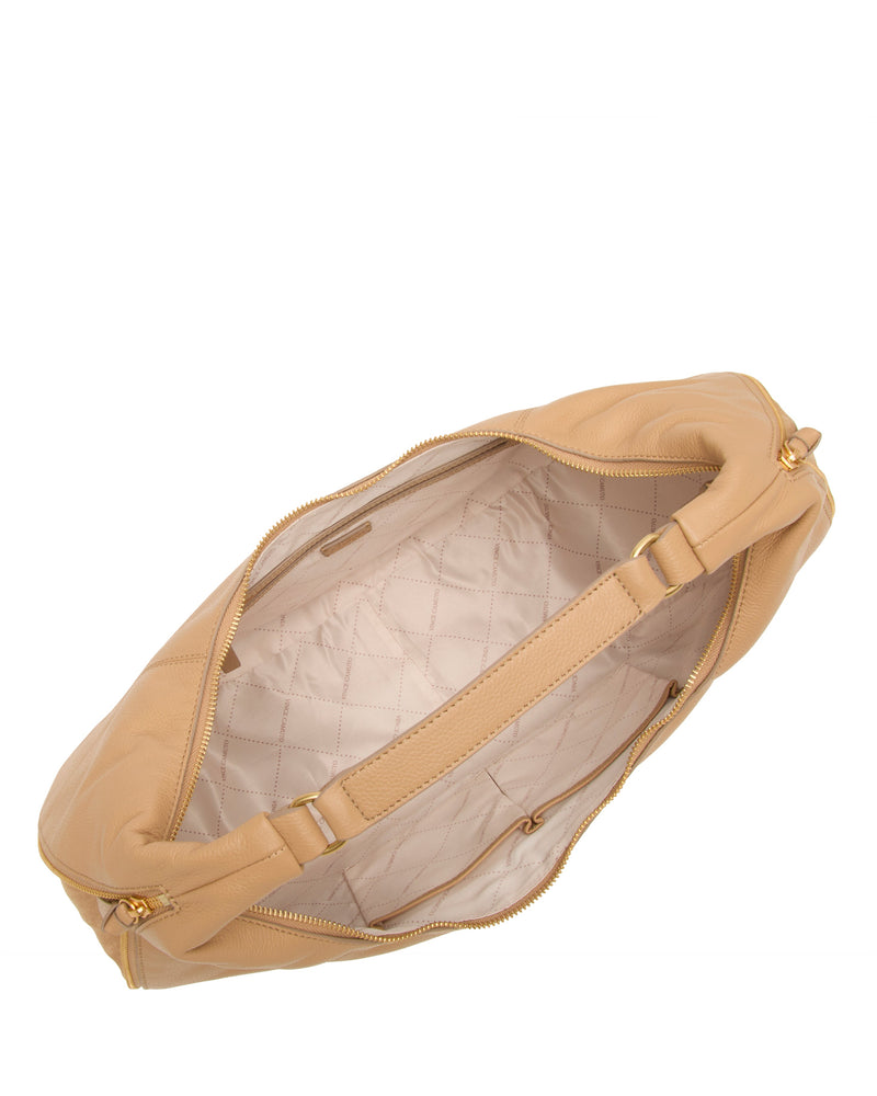 A top view of the Vince Camuto Kaela Hobo Bag—a tan leather shoulder bag with gold zippers—reveals its light quilted interior, inner pocket, and roomy main compartment.