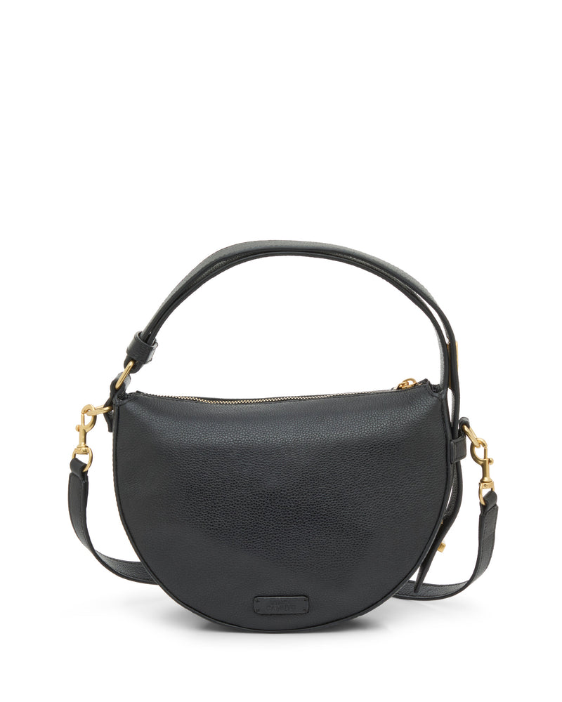 The Vince Camuto Karla Crossbody Bag is a sleek black leather half-moon design with gold-tone hardware, a short handle, and a detachable adjustable shoulder strap, pictured on a white background.