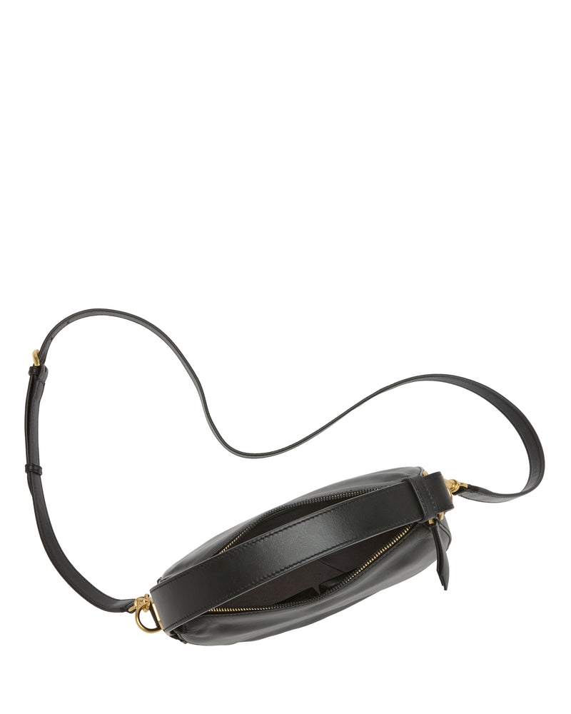Vince Camuto Karla Crossbody Bag in black leather, featuring a stylish half-moon silhouette, long adjustable strap, gold-tone hardware, and a zippered main compartment shown partially open against a white background.