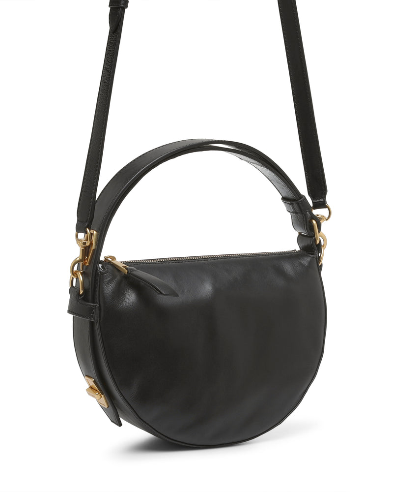 The Karla Crossbody Bag by Vince Camuto showcases a unique half-moon silhouette in black leather, accented with gold hardware, a top handle, and an adjustable shoulder strap.