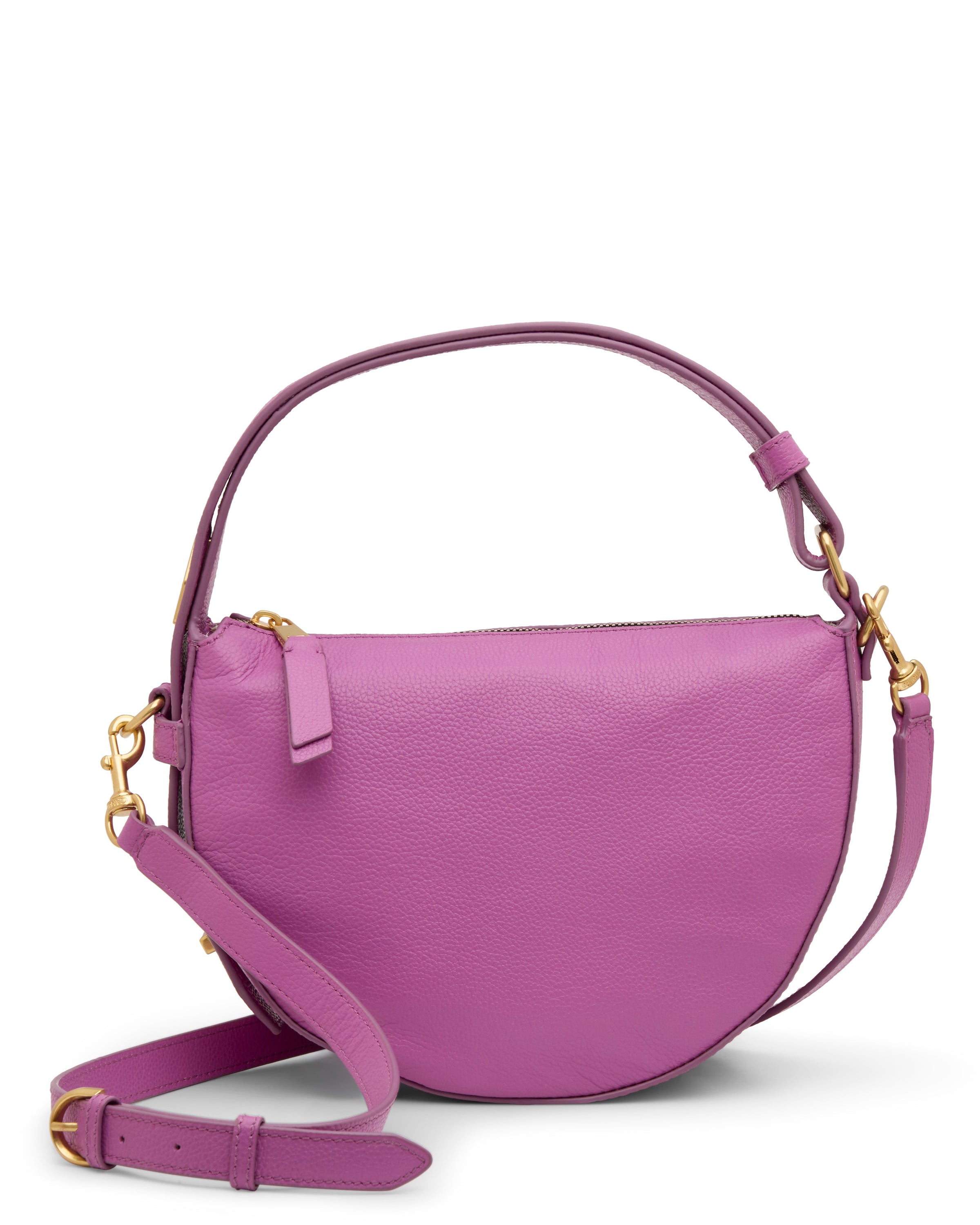 The Karla Crossbody Bag by Vince Camuto features a pink leather half-moon shape, gold hardware, a short handle, and a detachable, adjustable shoulder strap.