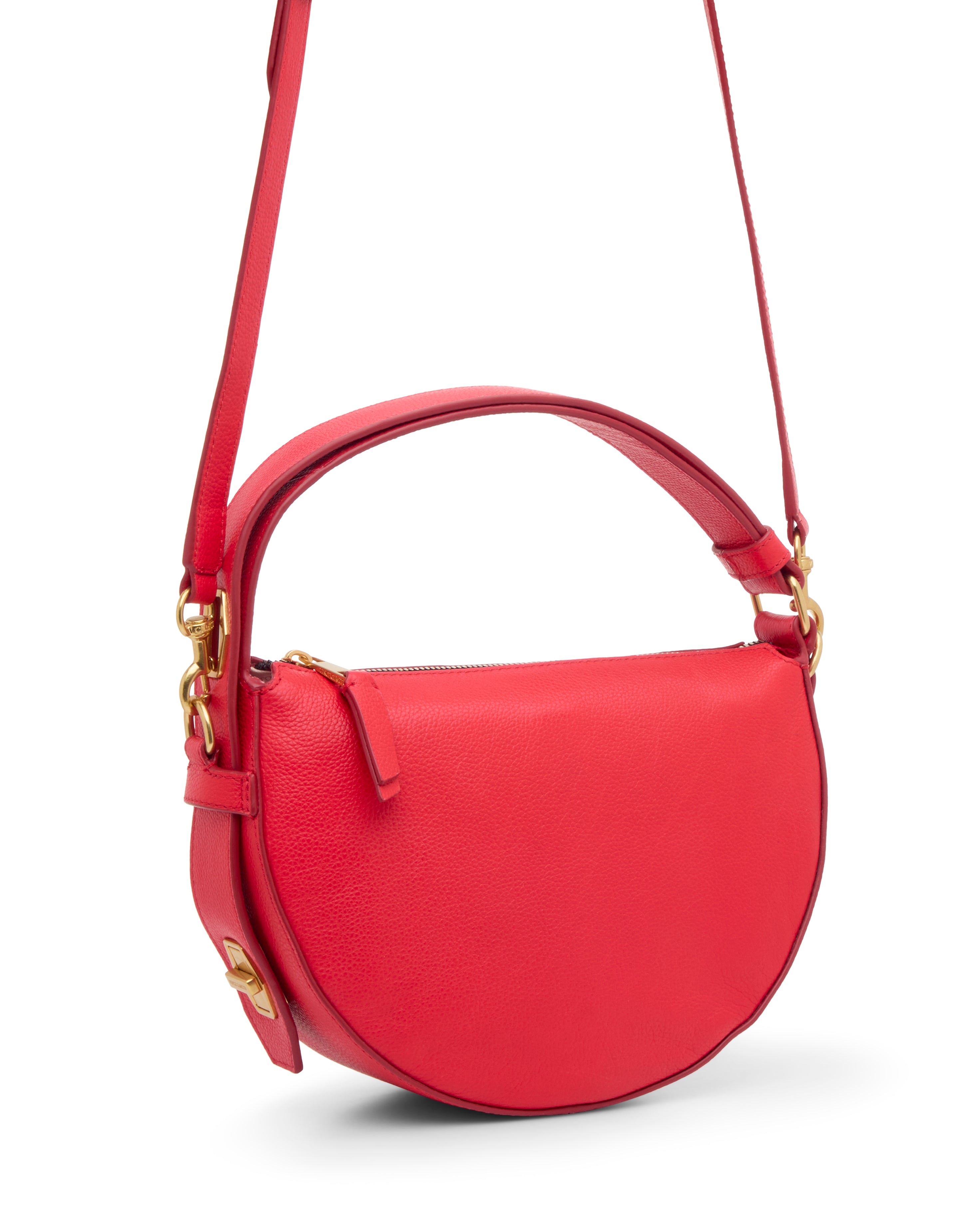 The Karla Crossbody Bag by Vince Camuto is a vibrant red, half-moon leather bag with a top handle, long adjustable strap, gold hardware, and zip closure.
