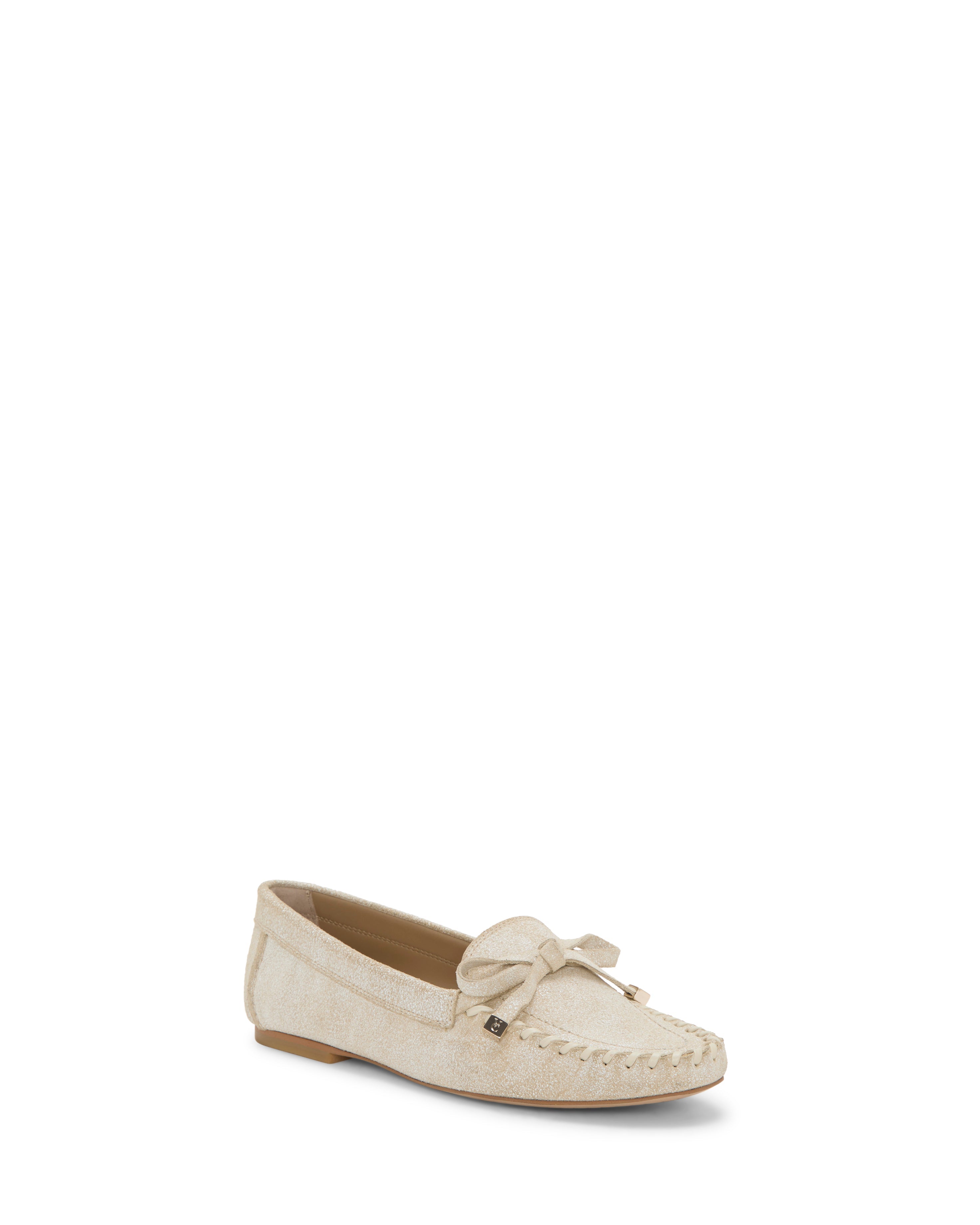 The Vince Camuto Katena Flat Loafer features beige suede, a bow detail, visible toe stitching, and a moc-inspired silhouette. Lightweight and comfortable with a flat sole, it's shown against a plain white background.