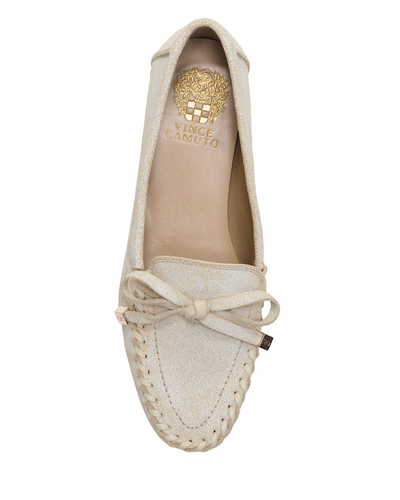 A top view of the beige Katena Flat Loafer by Vince Camuto shows moccasin-style stitching around the toe, a bow detail, and a gold Vince Camuto logo on the insole.
