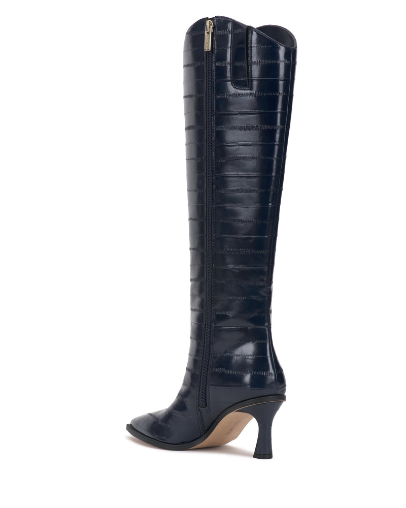 The Vince Camuto Kenlea Narrow Calf Knee High Boot is a knee-high, dark navy blue boot featuring a subtle textured pattern, a side zipper, rounded toe, and a mid-height heel, shown against a white background.