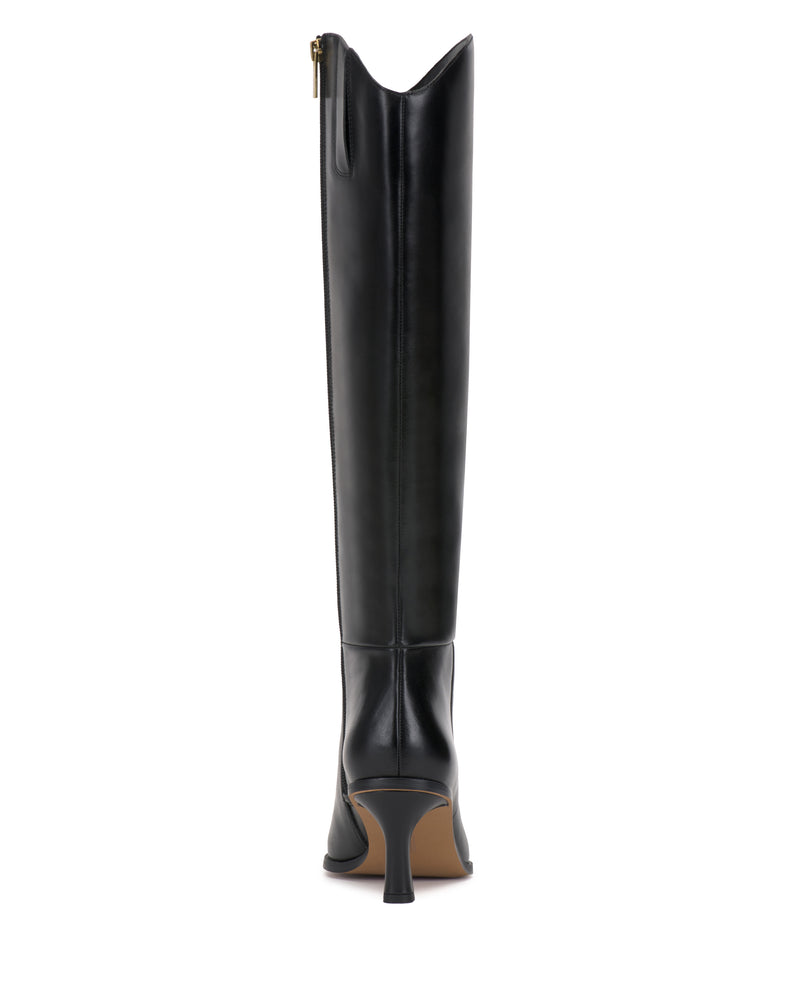 The Vince Camuto Kenlea Extra Wide Calf Knee High Boot is shown in black, featuring a pointed toe, stiletto heel, and a visible side zipper, viewed from the back against a white background.