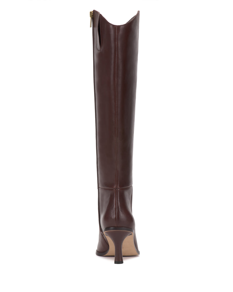 A back view of the Vince Camuto Kenlea Knee High Boot, featuring tall brown leather with a side zipper and a pointed, narrow heel.