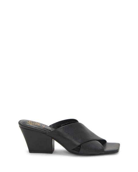 The Kespa Mule by Vince Camuto showcases a minimalist, modern design with a black leather wide crisscross upper, open toe, chunky block heel, and a distinctive gold detail on the insole near the heel.