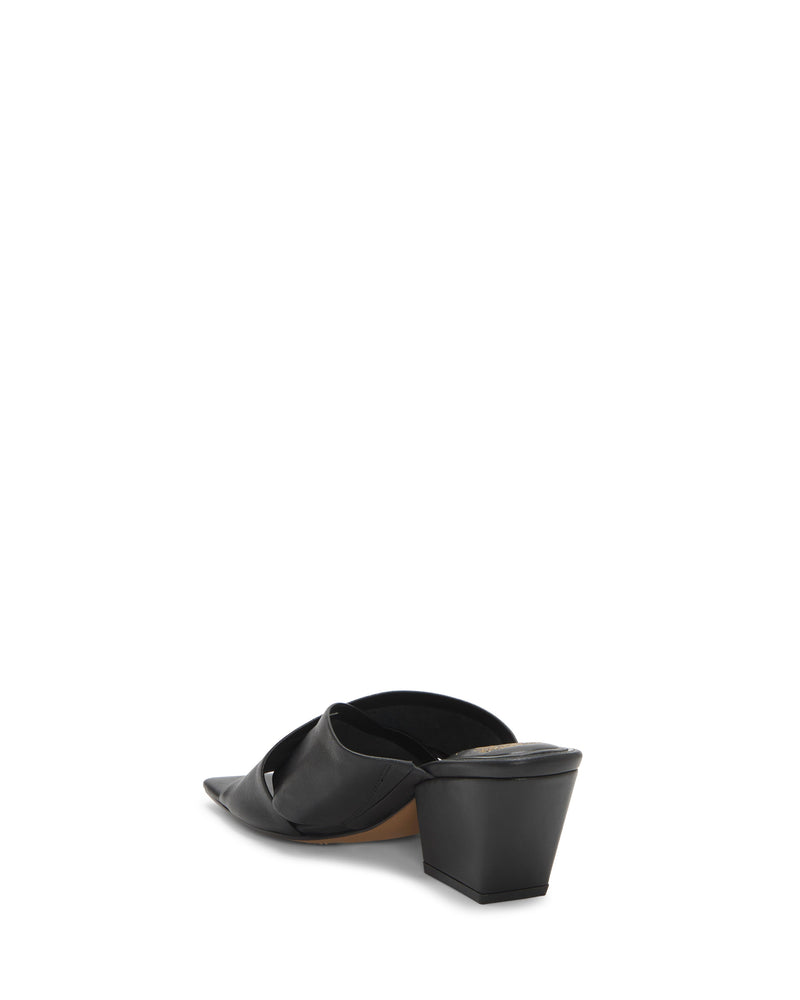 The Vince Camuto Kespa Mule features black leather, crisscross straps, a pointed toe, open back, and a block heel. Shown from the rear side against a white background.