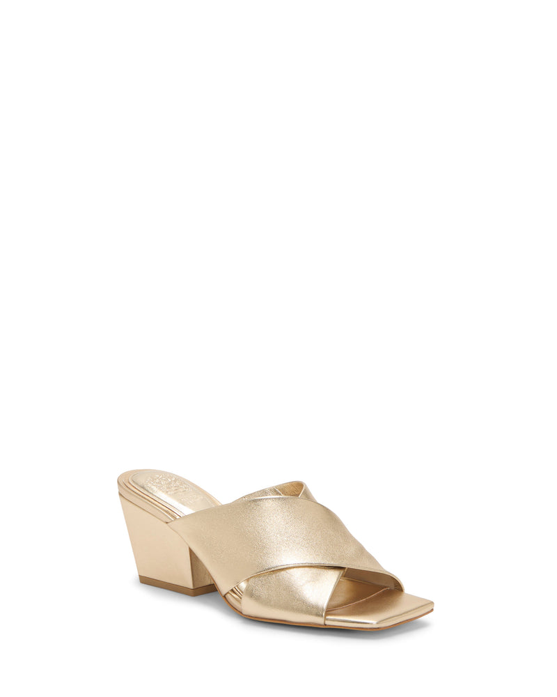 The Kespa Mule by Vince Camuto is a gold leather sandal with a crisscross upper, block heel, open square toe, and a subtle metallic sheen for an elegant finish.