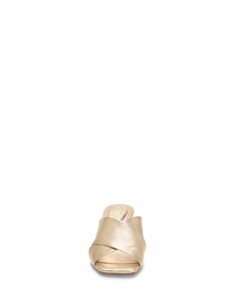 The Kespa Mule by Vince Camuto is a beige leather sandal with a crisscross upper and low block heel, shown from the front on a white background.