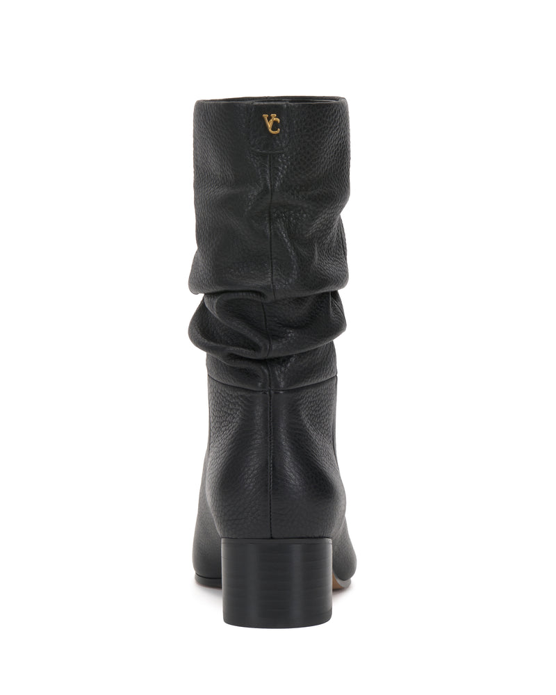 The Kuvania Bootie by Vince Camuto is shown from the back, featuring black pebbled leather, a block heel, and a small gold logo near the top.