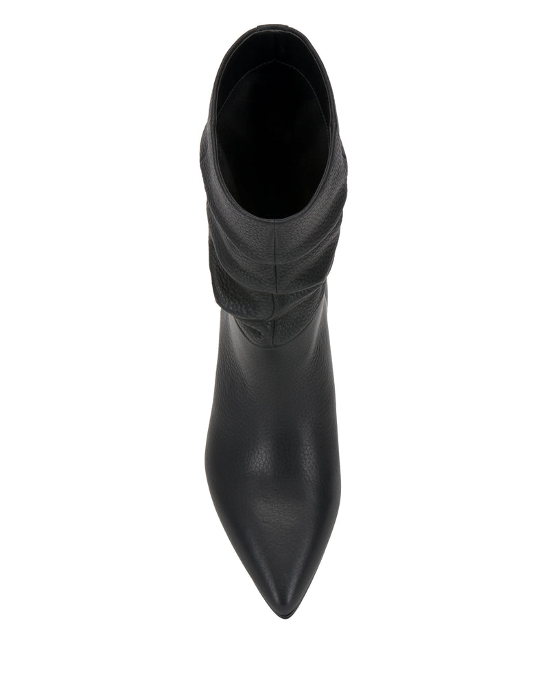 Top view of the Kuvania Bootie by Vince Camuto—a single black leather ankle boot with a pointed toe, photographed on a white background.