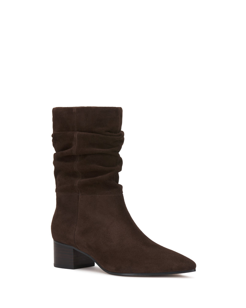 The Kuvania Bootie by Vince Camuto is a single dark brown suede mid-calf boot featuring a slightly slouched shaft, pointed toe, and low block heel, displayed on a white background.