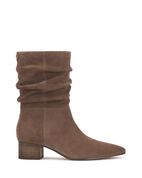 The Kuvania Bootie by Vince Camuto is a mid-calf taupe suede boot featuring a slightly slouched shaft, pointed toe, and a low stacked wooden heel.