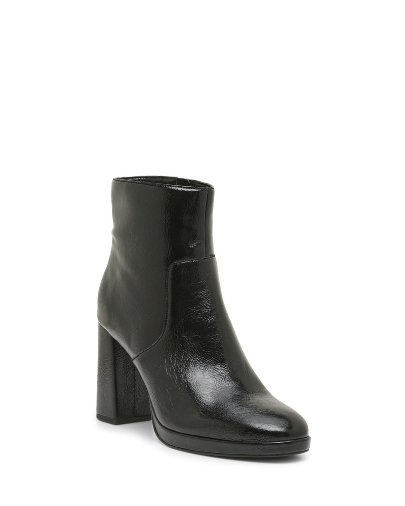 Black and shiny, the Laylei Bootie by Vince Camuto features an ankle-high silhouette with a chunky block heel and rounded toe, showcased against a white background. The bootie’s smooth texture and minimalist design—free from visible laces or zippers—make it an elegant choice for effortless style.