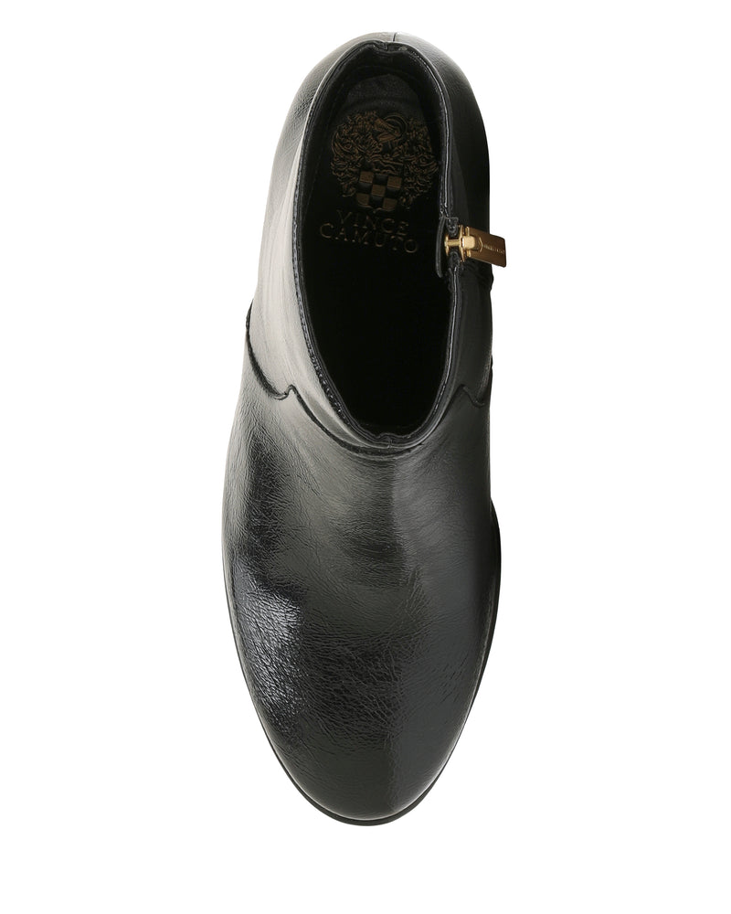 Top view of a single shiny black leather Vince Camuto Laylei Bootie, ankle-high with a decorative brass buckle on the side and a stylish block heel, isolated on a white background.