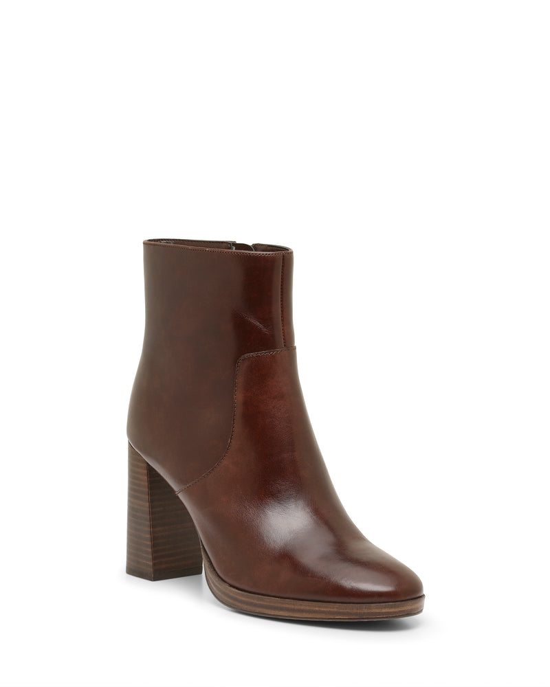 The Laylei Bootie by Vince Camuto is a brown leather ankle-high bootie with a high block heel and side zipper, featuring a smooth, polished finish and a slightly pointed toe, shown on a white background.