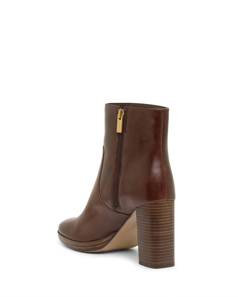 A Vince Camuto Laylei Bootie in brown leather, showcasing an ankle-high silhouette with a high stacked wooden block heel, side zipper, and rounded toe, photographed against a plain white background.