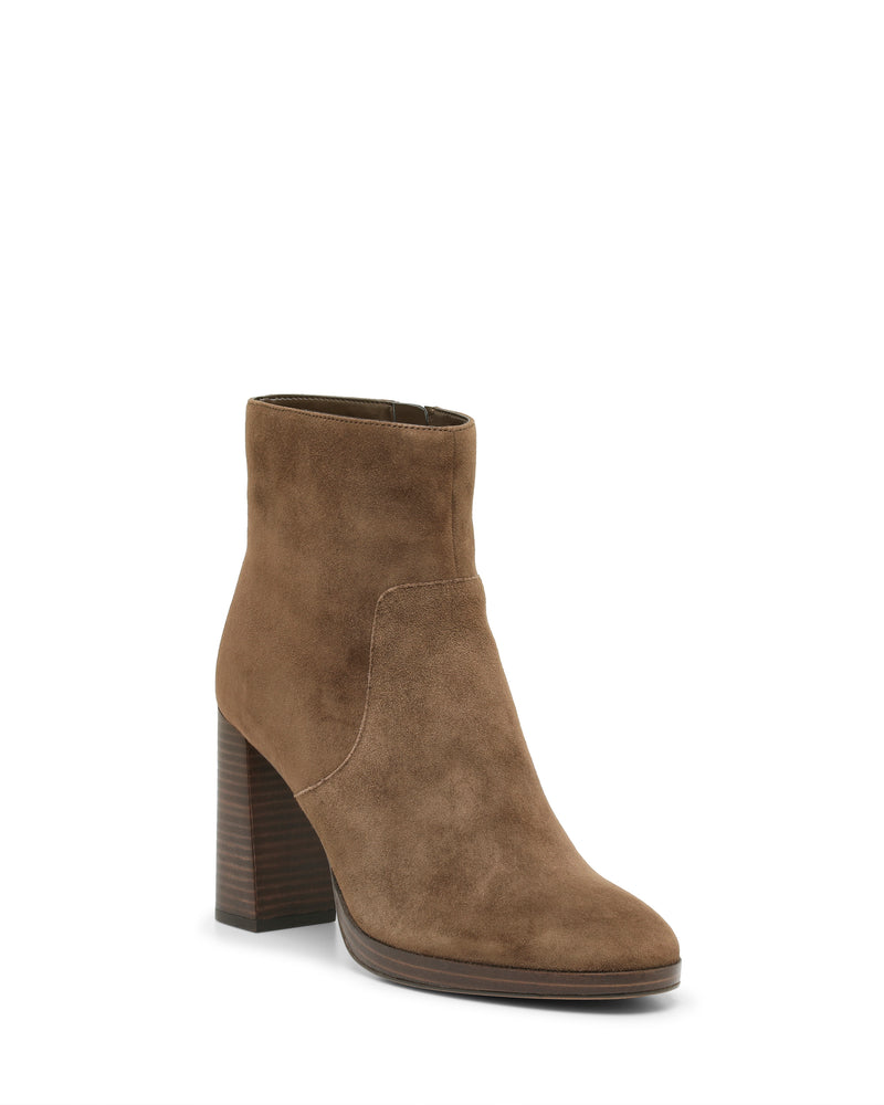 The Laylei Bootie by Vince Camuto features tan suede, a high chunky wooden heel, and a slightly pointed toe; this ankle-high bootie is displayed on a white background.