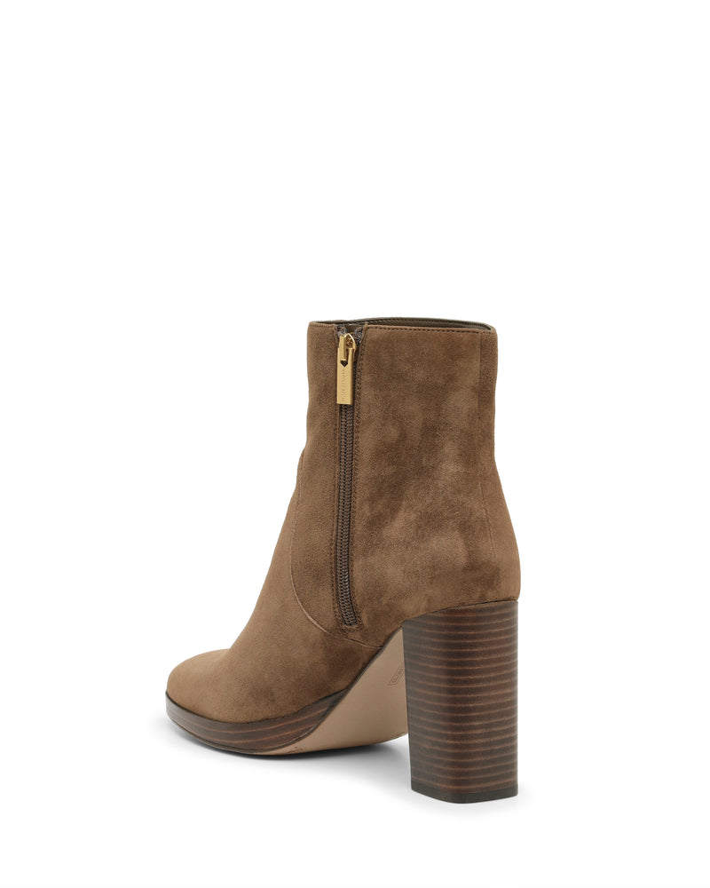 Elevated at an angle against a white background, the Vince Camuto Laylei Bootie showcases rich brown suede in an ankle-high silhouette, featuring a side zipper and a sturdy stacked block heel—seamlessly blending style and comfort for all-occasion versatility.