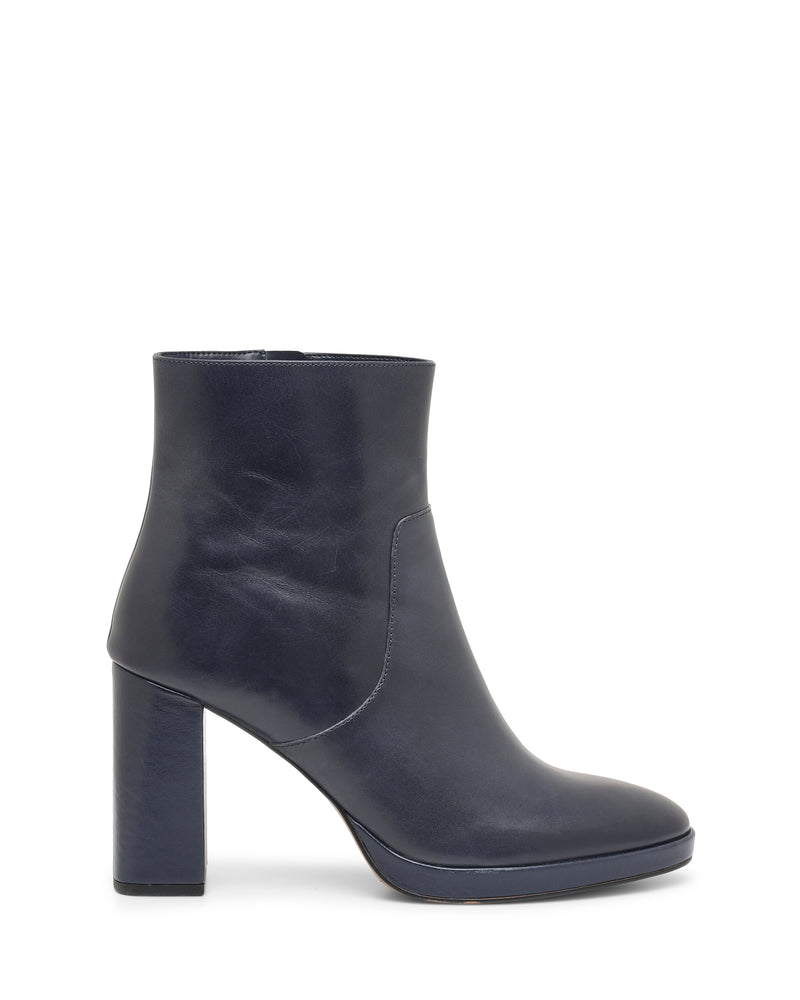 The Vince Camuto Laylei Bootie in dark navy blue leather showcases a high block heel, round toe, and side stitching detail. Displayed in profile, this boot features a smooth polished finish and a minimalistic design.