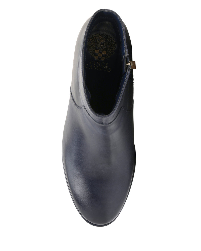 A top view of a single Laylei Bootie by Vince Camuto in navy blue leather, featuring a slightly pointed toe and a side zipper that highlights its chic ankle-high silhouette.
