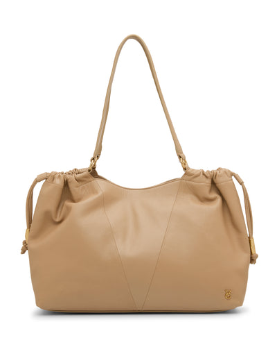 The Vince Camuto Leane Tote Bag is a tan leather shoulder bag with gathered top details, adjustable drawstring sides, dual straps, and a small gold logo at the lower right corner.