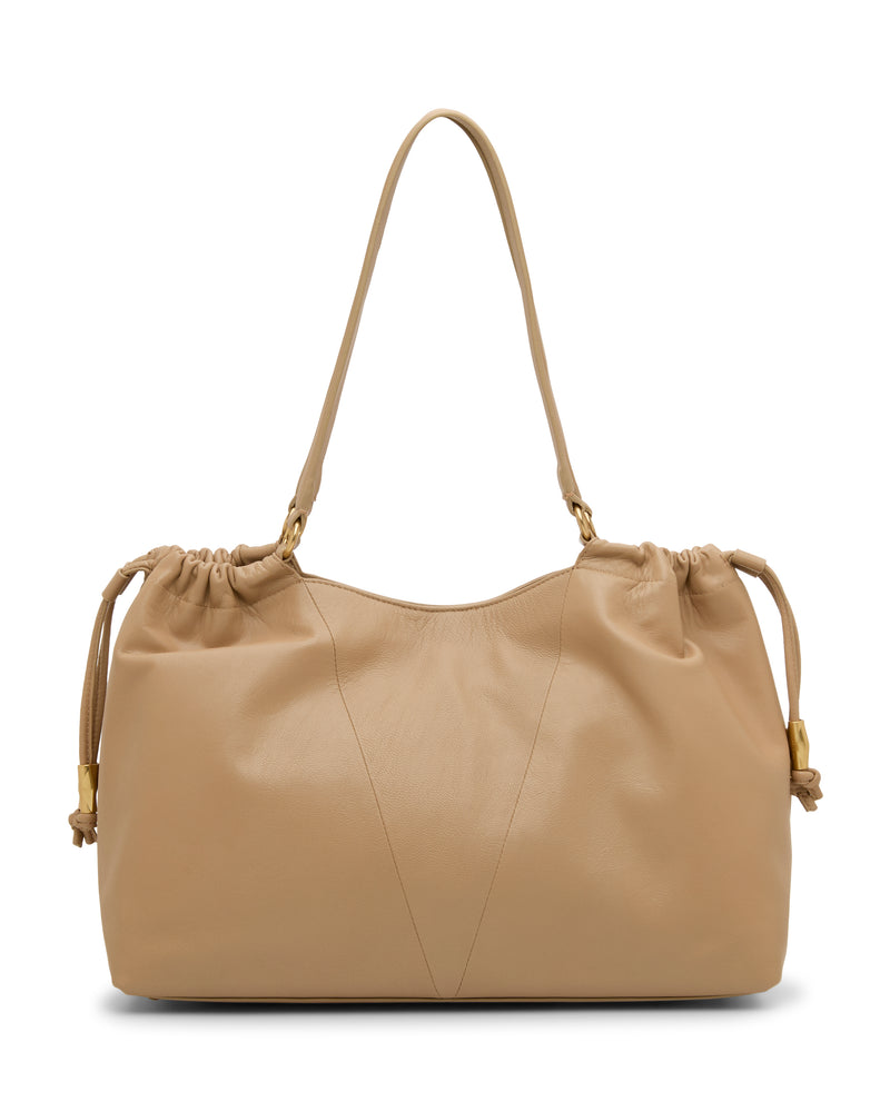 The Vince Camuto Leane Tote Bag is a large, beige leather shoulder bag featuring a single strap, gathered drawstring sides, gold-tone hardware, a soft texture, and a minimalist design.
