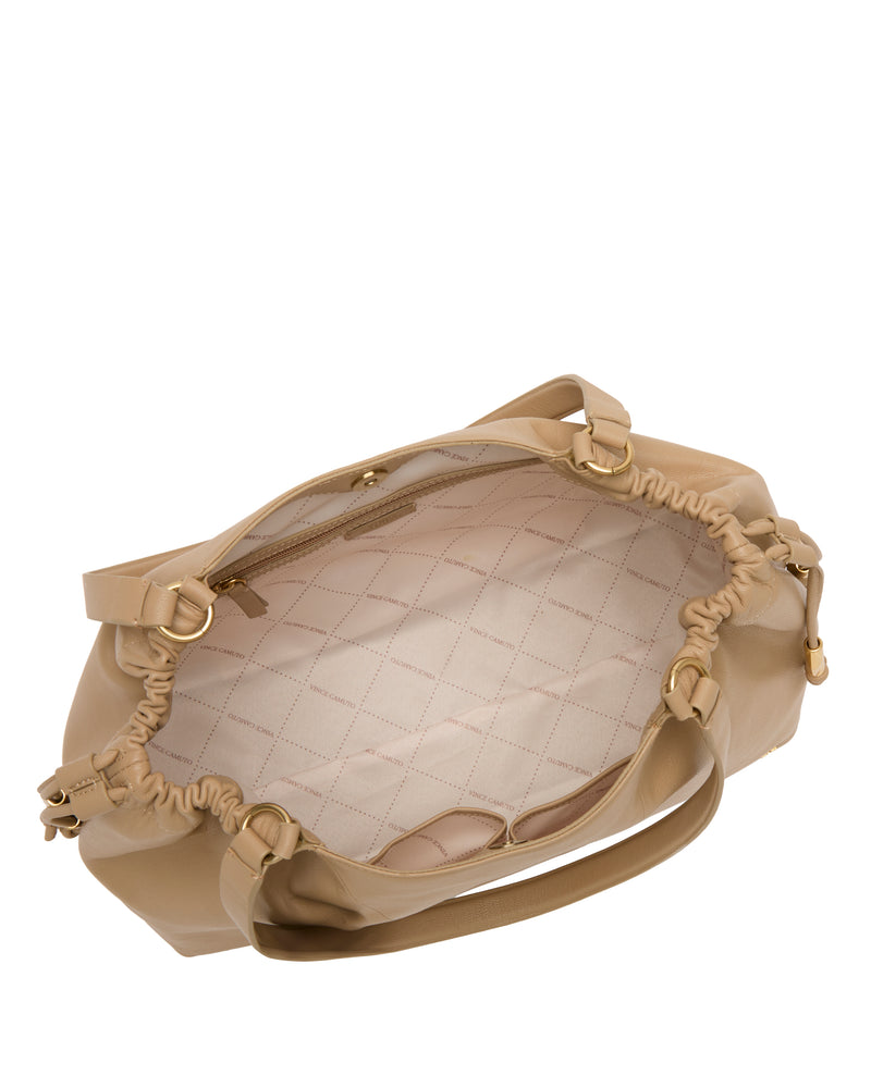 Top view of the Vince Camuto Leane Tote Bag in beige with quilted light lining, gathered sides, gold hardware, and multiple interior pockets.