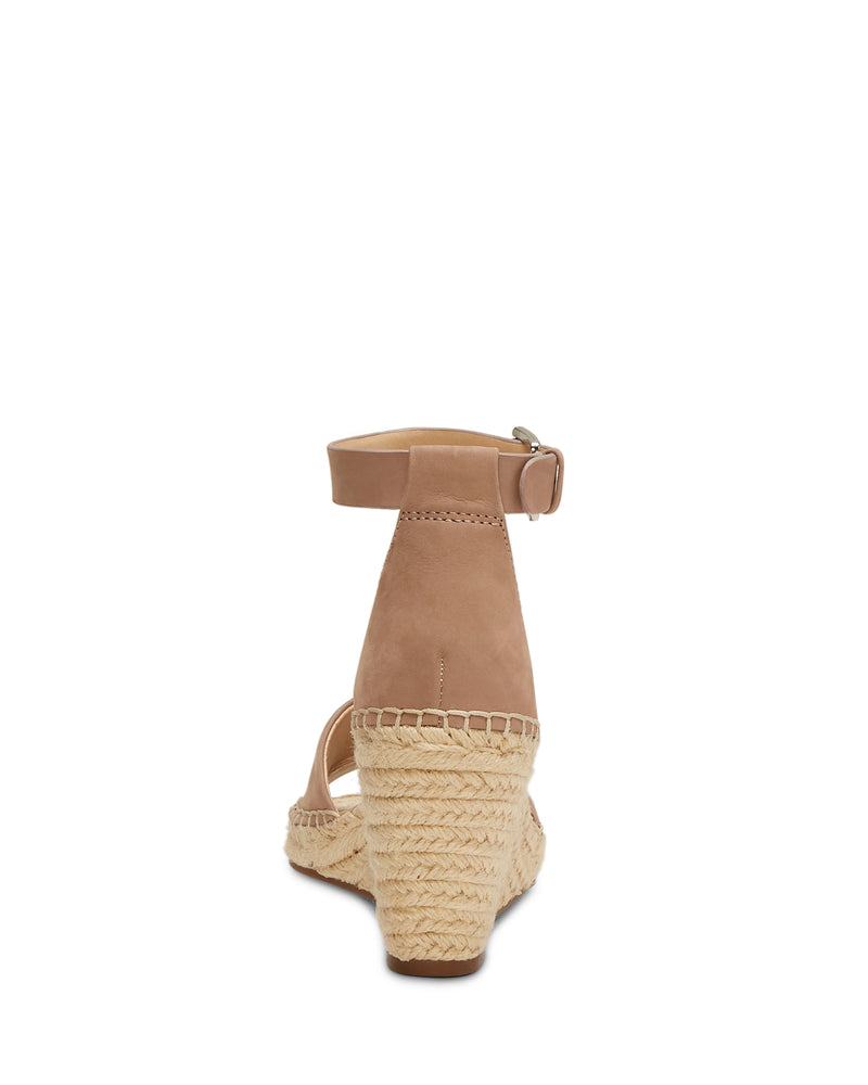 Rear view of the Vince Camuto Leera Espadrille Wedge Sandal in tan, showcasing an ankle strap with buckle closure, a textured woven rope wedge heel, and a closed heel counter.