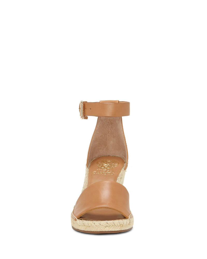Front view of the Leera Espadrille Wedge Sandal by Vince Camuto, featuring a tan color, ankle strap with buckle, open toe, and woven espadrille sole.