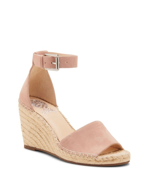 The Leera Espadrille Wedge Sandal by Vince Camuto is a single pink suede wedge sandal featuring an open toe, an ankle strap with buckle, and a braided jute platform heel.