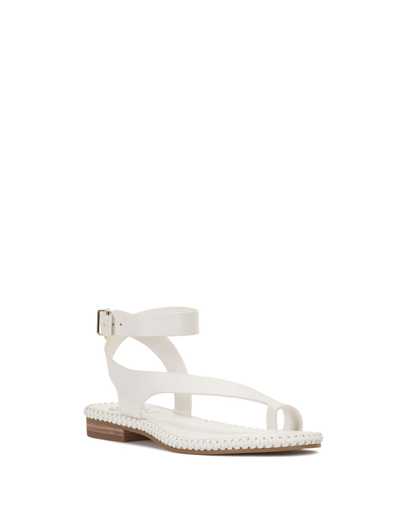 The Libahs Sandal by Vince Camuto is a white modern flat with a toe loop, braided sole trim, adjustable ankle buckle strap, and low wooden heel for a minimalist look.