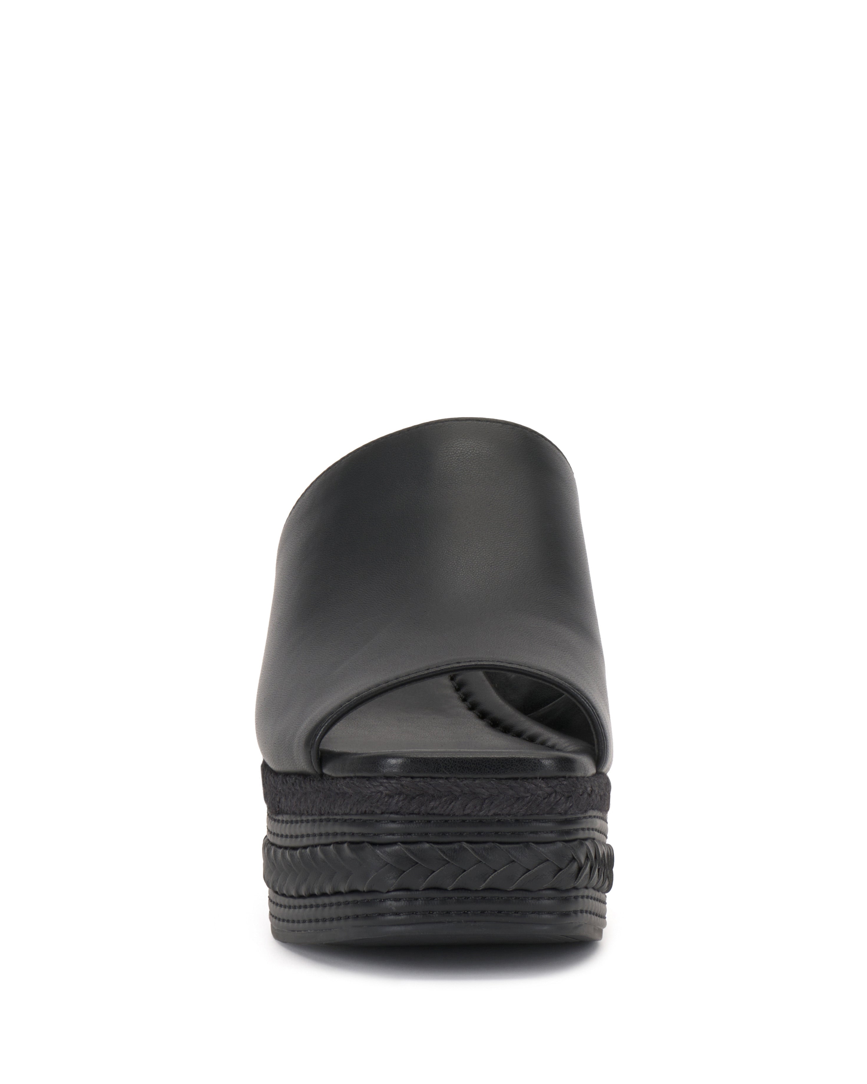 Front view of the Vince Camuto Lierna Espadrille Wedge Sandal in black, featuring a closed upper, open toe, and woven platform sole. The slip-on sandal is shown against a plain white background.