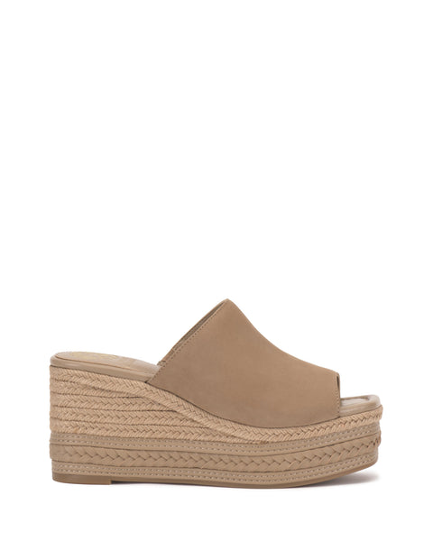 The Vince Camuto Lierna Espadrille Wedge Sandal showcases a tan, closed-toe slip-on design with an open back and rope-wrapped platform sole, blending stylish looks with easy wear.