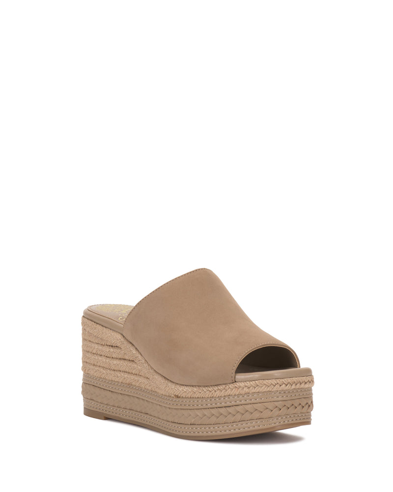 The Vince Camuto Lierna Espadrille Wedge Sandal features a tan color, espadrille platform wedge, open toe, slip-on style, and a textured woven sole.
