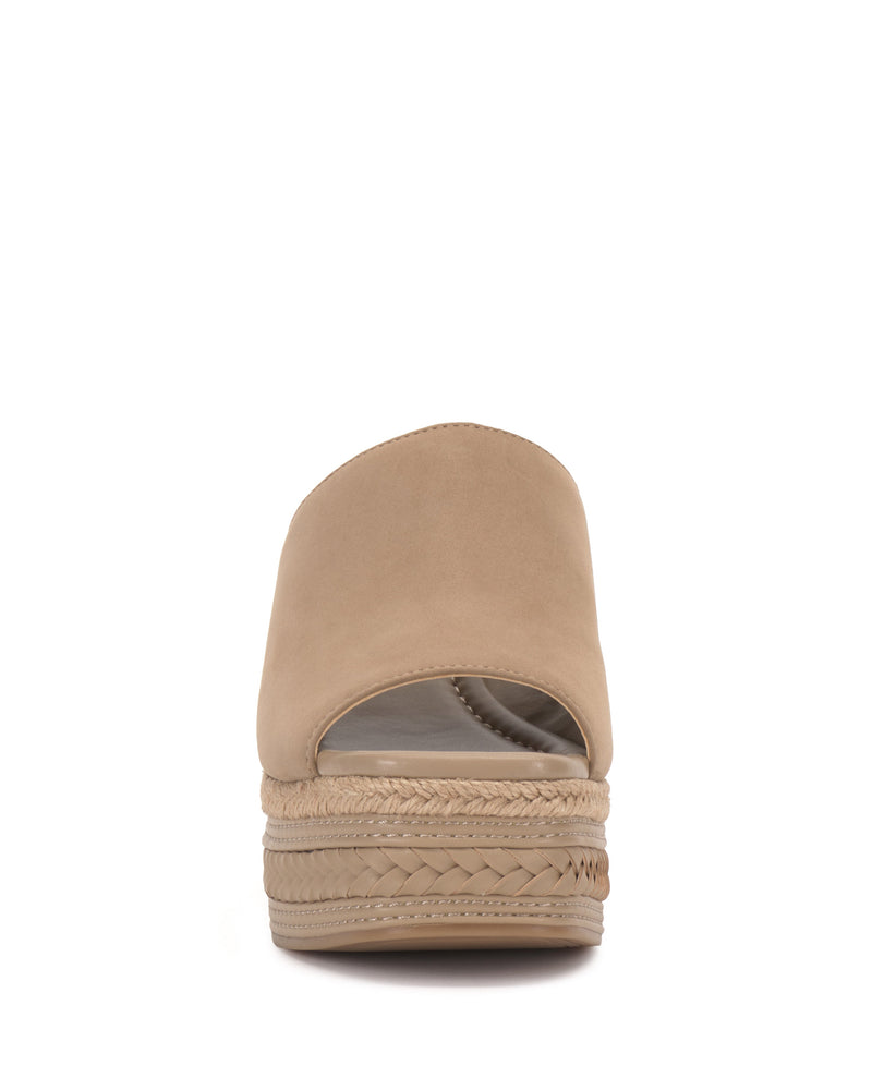 Front view of the Vince Camuto Lierna Espadrille Wedge Sandal—a beige slip-on with a woven platform wedge sole and closed toe—set against a plain white background.