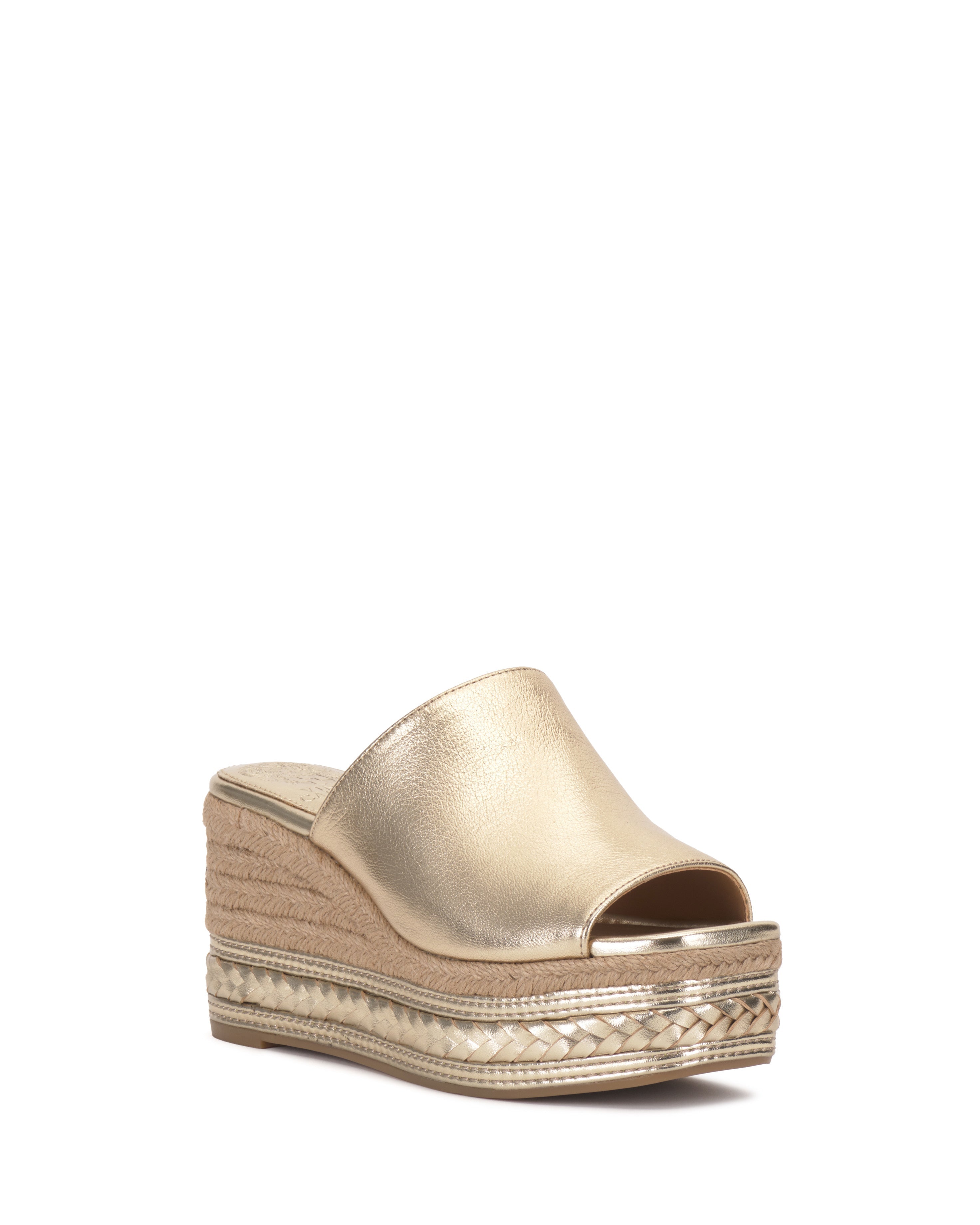 The Vince Camuto Lierna Espadrille Wedge Sandal features a gold metallic open toe, jute and braided accents, and a wedge espadrille platform, showcased against a plain white background.