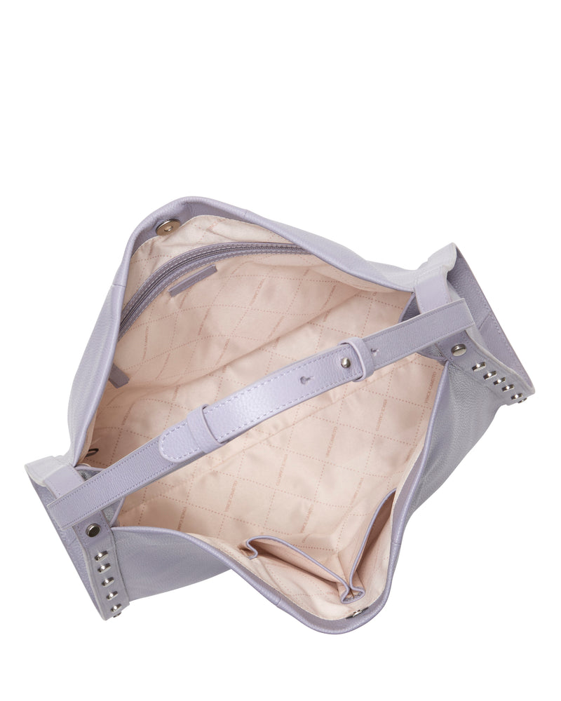 Open the Vince Camuto Lisha Tote Bag in lavender with studded accents, revealing a quilted pale pink interior, inner zipper pocket, and a strap across the opening—ideal as a modern everyday tote.