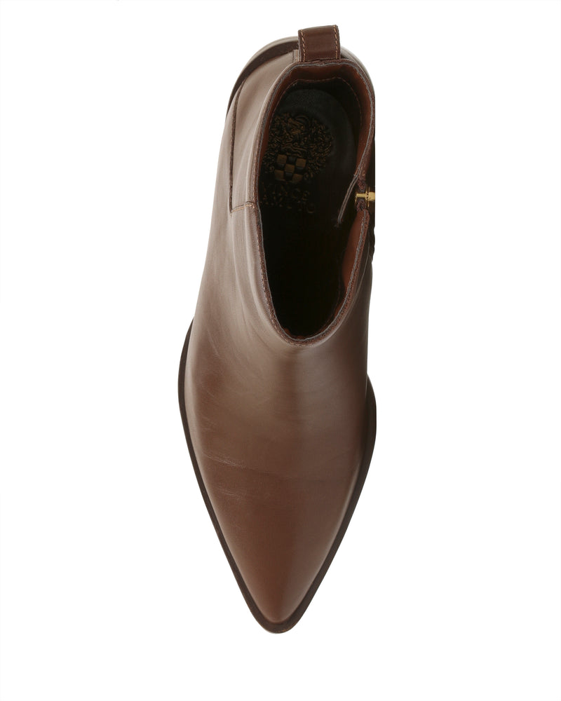 A top view of the Vince Camuto Lorelai Bootie, featuring brown leather, a pointed toe, block heel, and side zipper, displayed on a plain white background to highlight its modern style.