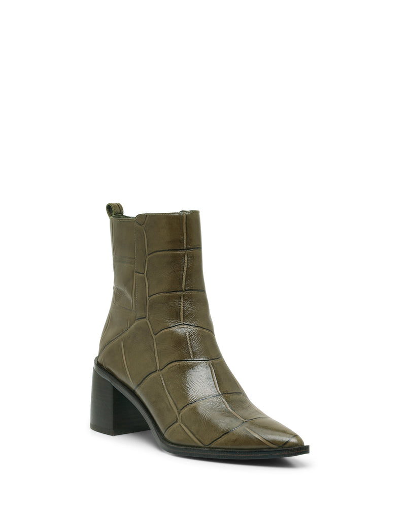 The Lorelai Bootie by Vince Camuto features an olive green, crocodile-embossed design with a pointed toe, side zipper, and chunky block heel, showcased against a white background for a distinctly modern style.