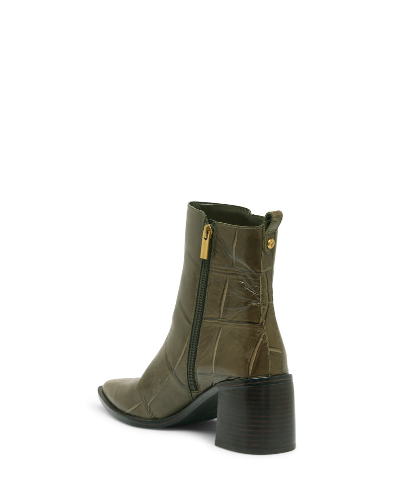 Lorelai Bootie by Vince Camuto in olive green features a mid-calf silhouette with a chunky dark block heel, side zipper, and a textured patterned finish. The pointed toe design is angled to showcase the zipper and back, emphasizing its modern style.